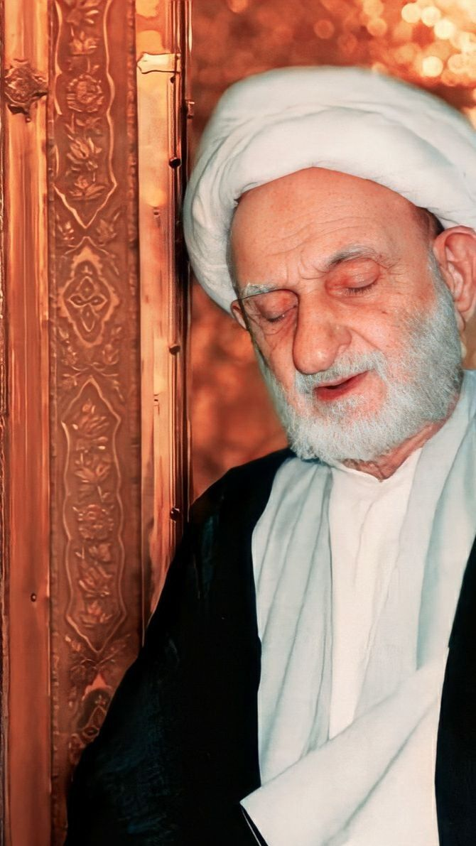 Elderly Islamic scholar with white turban and beard, traditional Shia attire, neutral background