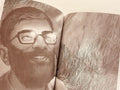 Sepia illustration of a bearded man with glasses smiling, featured in an Islamic book.