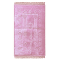Pink Islamic prayer mat with floral patterns and decorative fringe edges