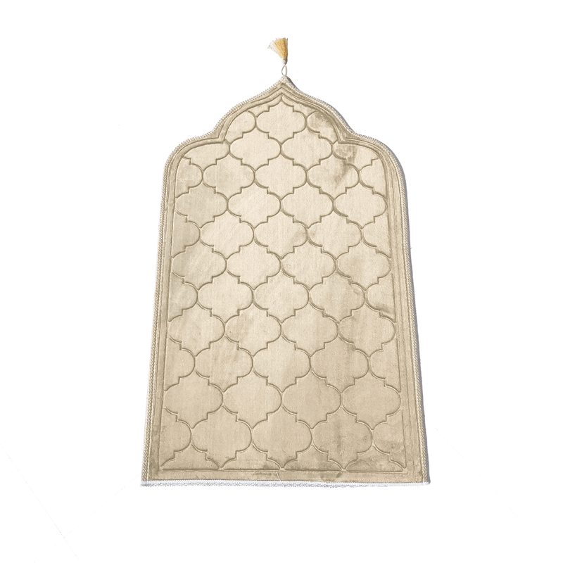 Beige Islamic prayer mat with geometric pattern and tasseled top on white background
