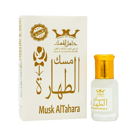Musk Al Tahara perfume oil bottle with gold cap beside white and gold packaging box