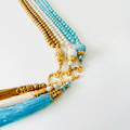 Islamic prayer beads with gold, white, and turquoise pearls, crescent charms, and tassels