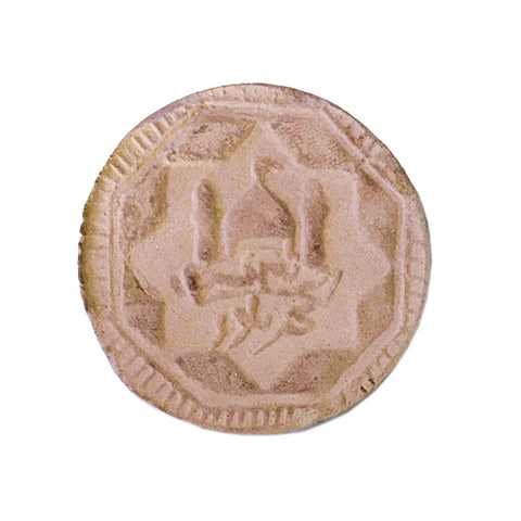 Karbala clay prayer turbah with embossed mosque design, used in Shia Islamic worship